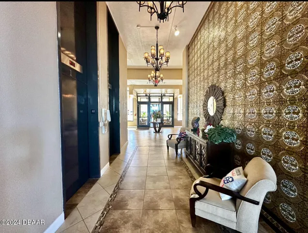 a dining room with furniture and a chandelier