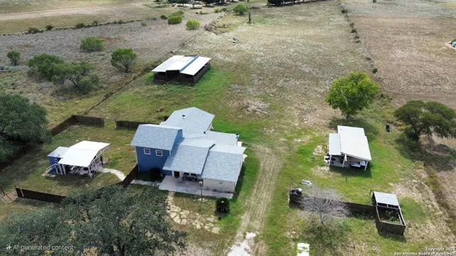 an aerial view of a house with outdoor space