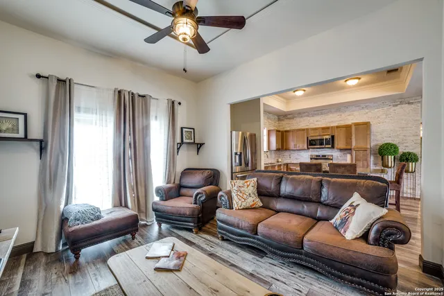 a living room with furniture and a wooden floor