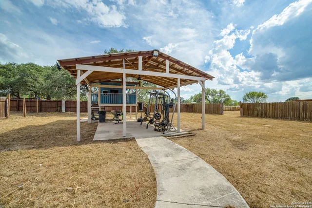 a view of a patio with table and chairs under an umbrella
