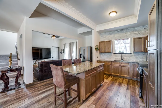 a large kitchen with a table and chairs