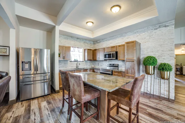 a kitchen with refrigerator and microwave