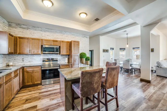 a view of kitchen with microwave stove top oven and cabinets