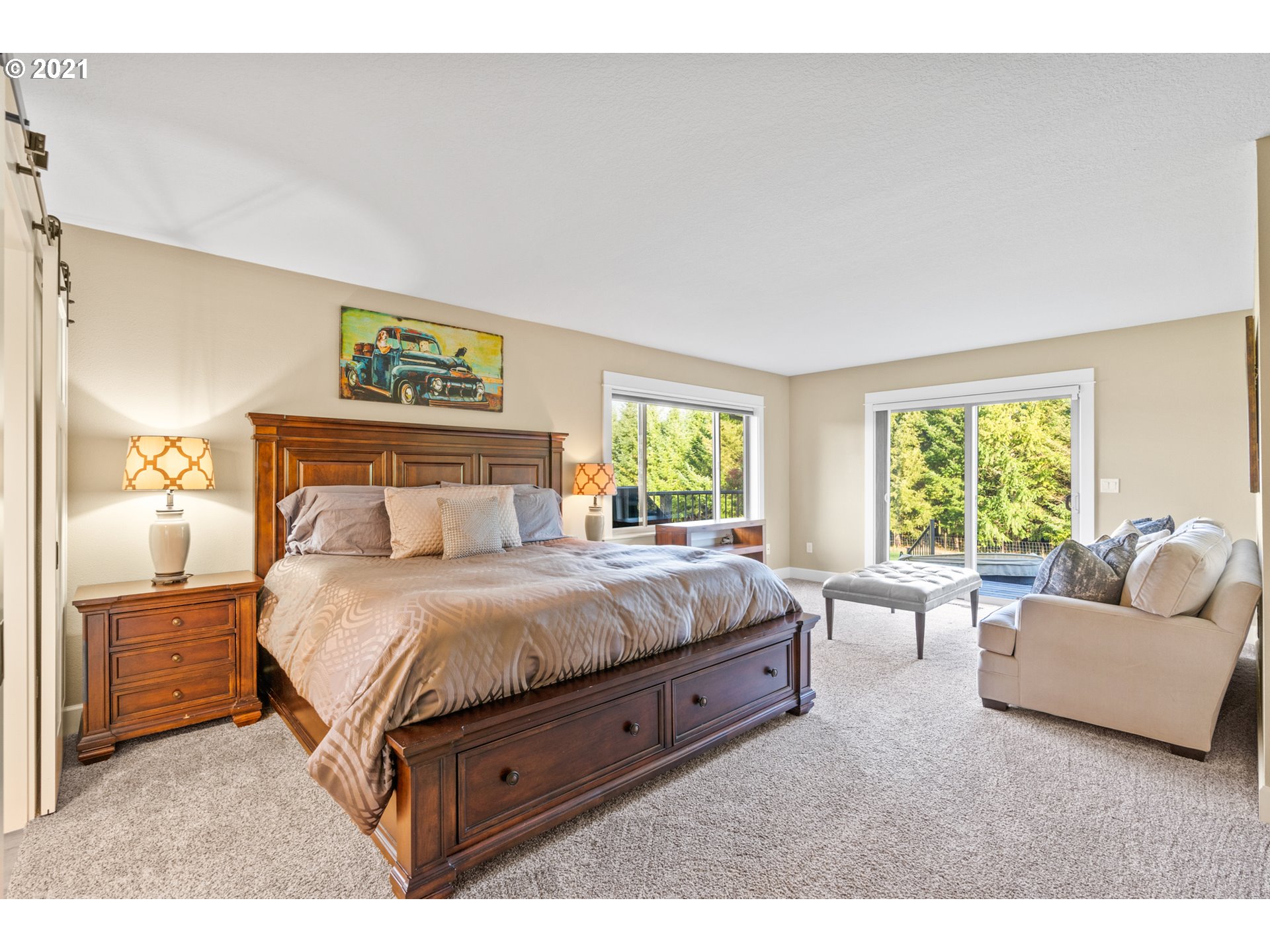 15695 South Carus Road Oregon City, OR 97045 - Photo 14 of 32 a spacious bedroom with a bed and a couch