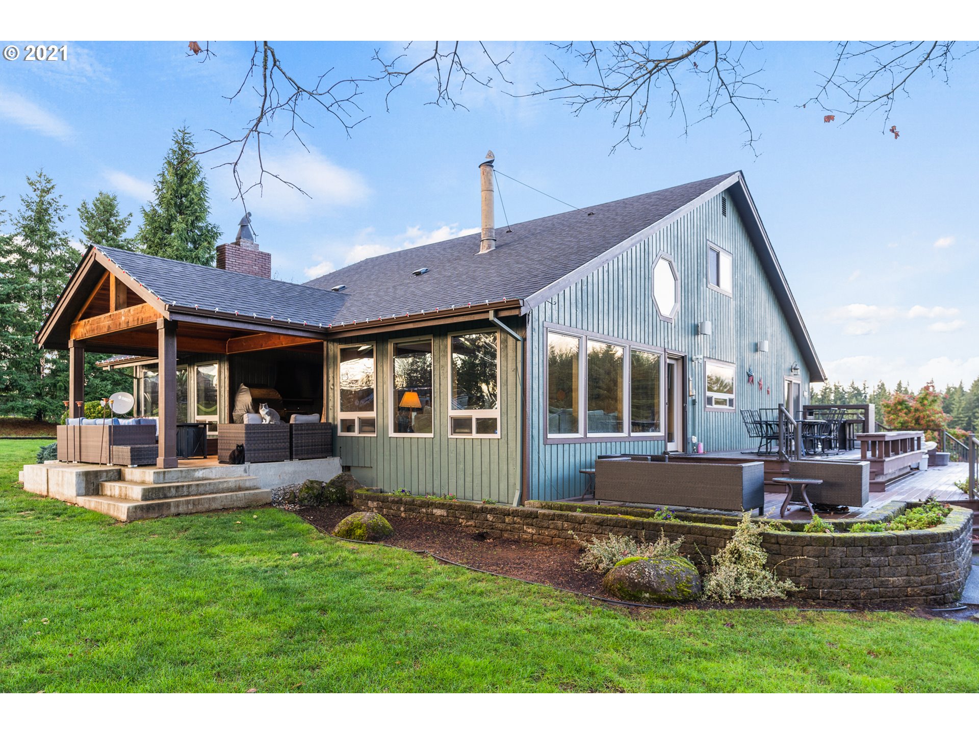 15695 South Carus Road Oregon City, OR 97045 - Photo 21 of 32 a front view of a house with a yard table and chairs
