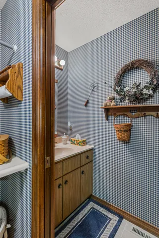 a bedroom with a bed and a flat tv screen on dresser