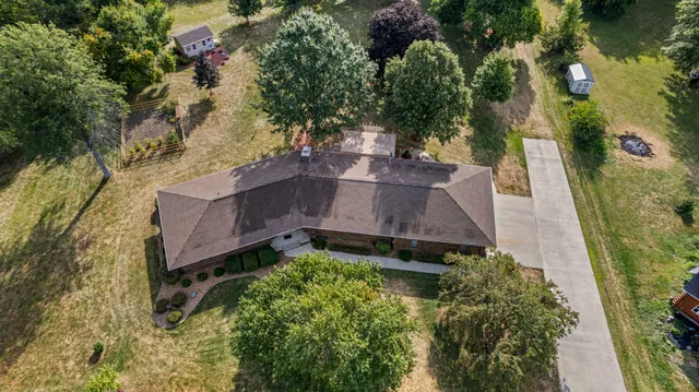 an aerial view of a house with a yard