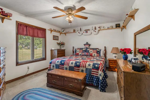 a bedroom with a bed and a dresser in it