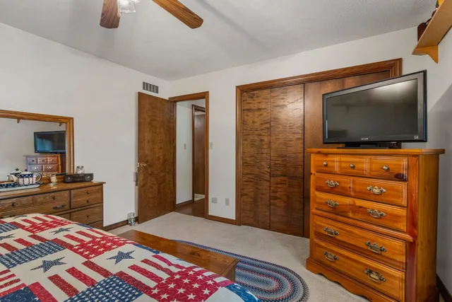 a bedroom with bed and wooden floor