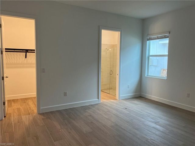 an empty room with wooden floor and sliding door