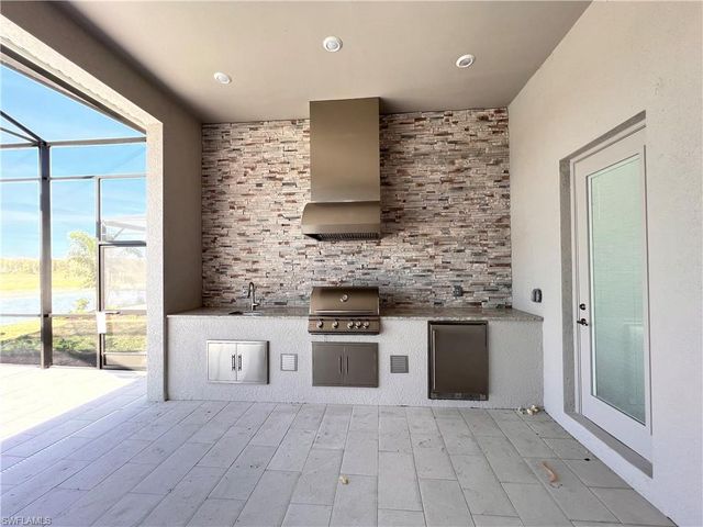 a large white kitchen with a stove and a refrigerator