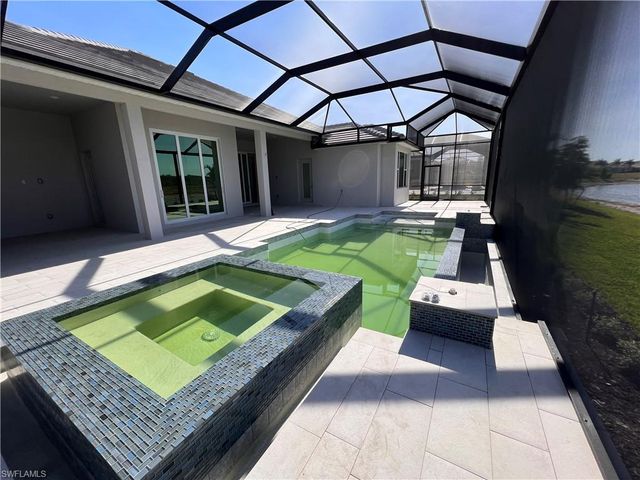 a view of a backyard with chairs and a patio