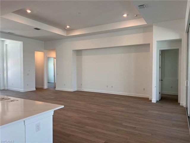 an empty room with wooden floor