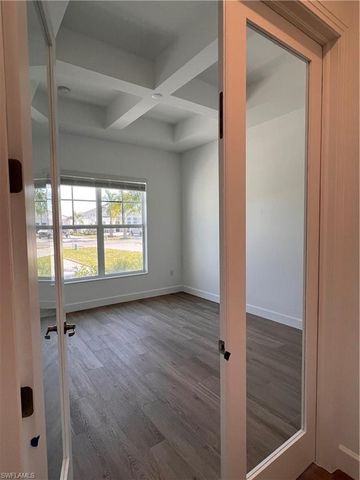 an empty room with wooden floor and a window