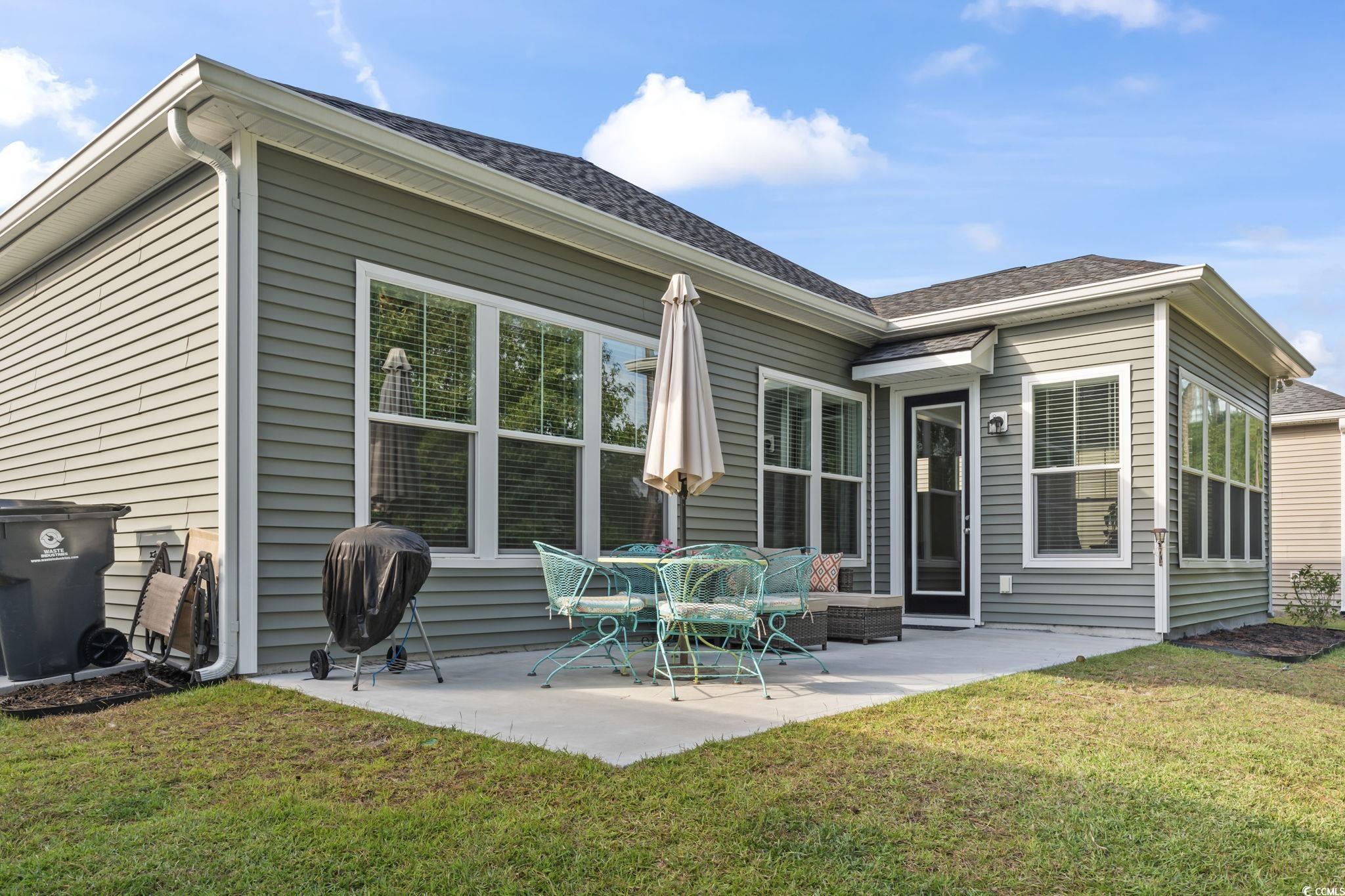 502 Bumble Circle Murrells Inlet, SC 29576 - Photo 31 of 39 Back of property featuring a yard and a patio area