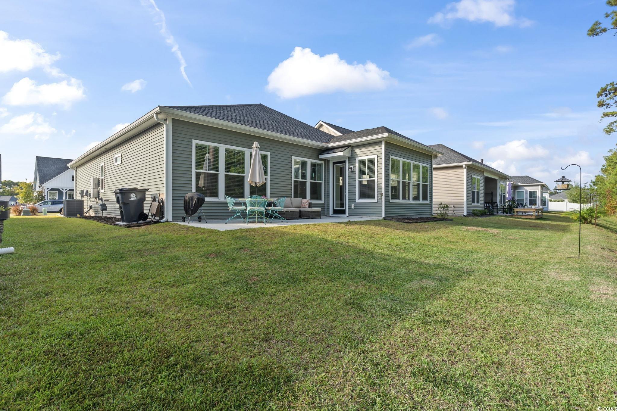 502 Bumble Circle Murrells Inlet, SC 29576 - Photo 32 of 39 Rear view of house featuring a patio and a lawn