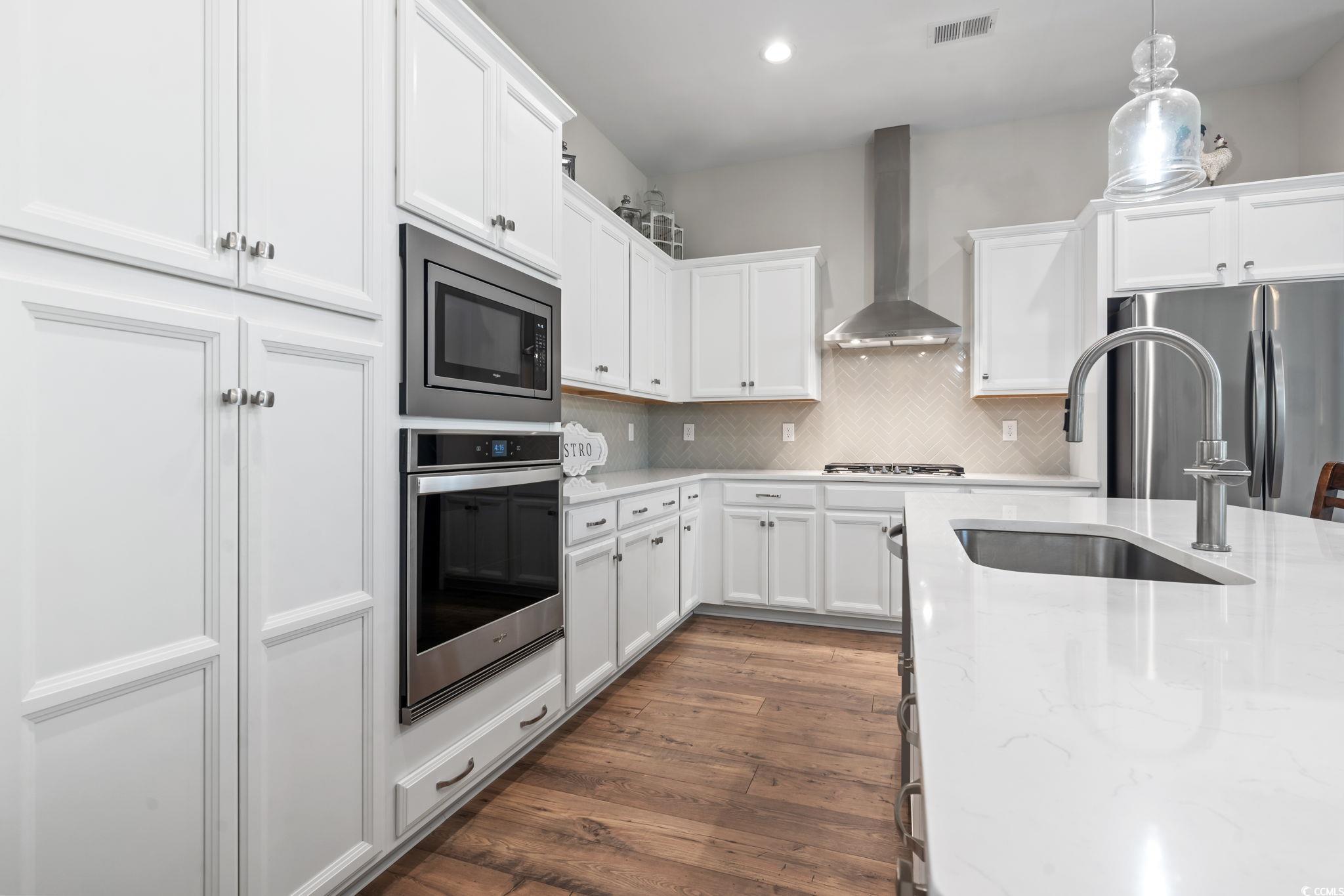 502 Bumble Circle Murrells Inlet, SC 29576 - Photo 7 of 39 Kitchen featuring pendant lighting, dark wood-type