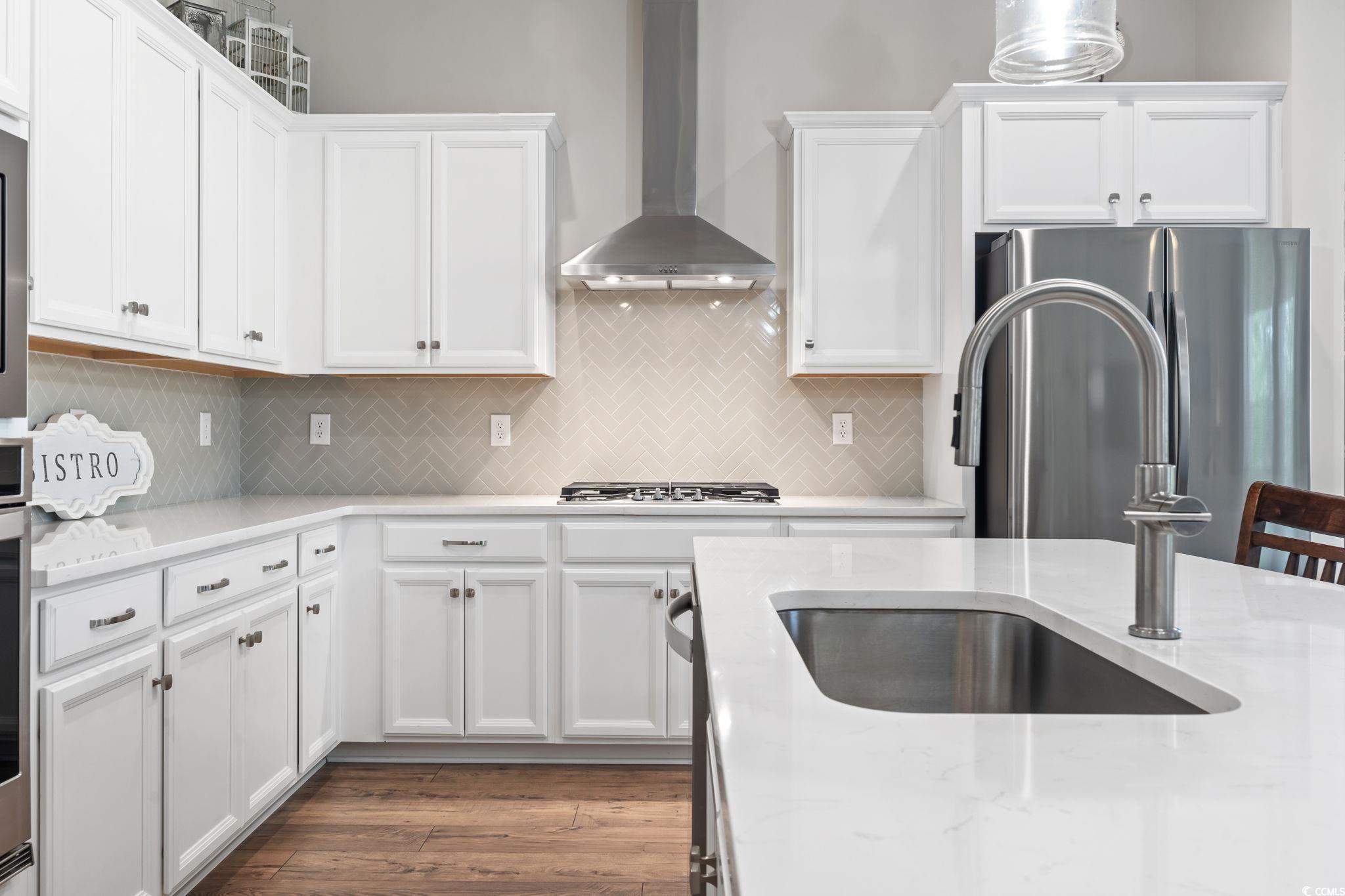 502 Bumble Circle Murrells Inlet, SC 29576 - Photo 8 of 39 Kitchen with light stone counters, white cabinets,