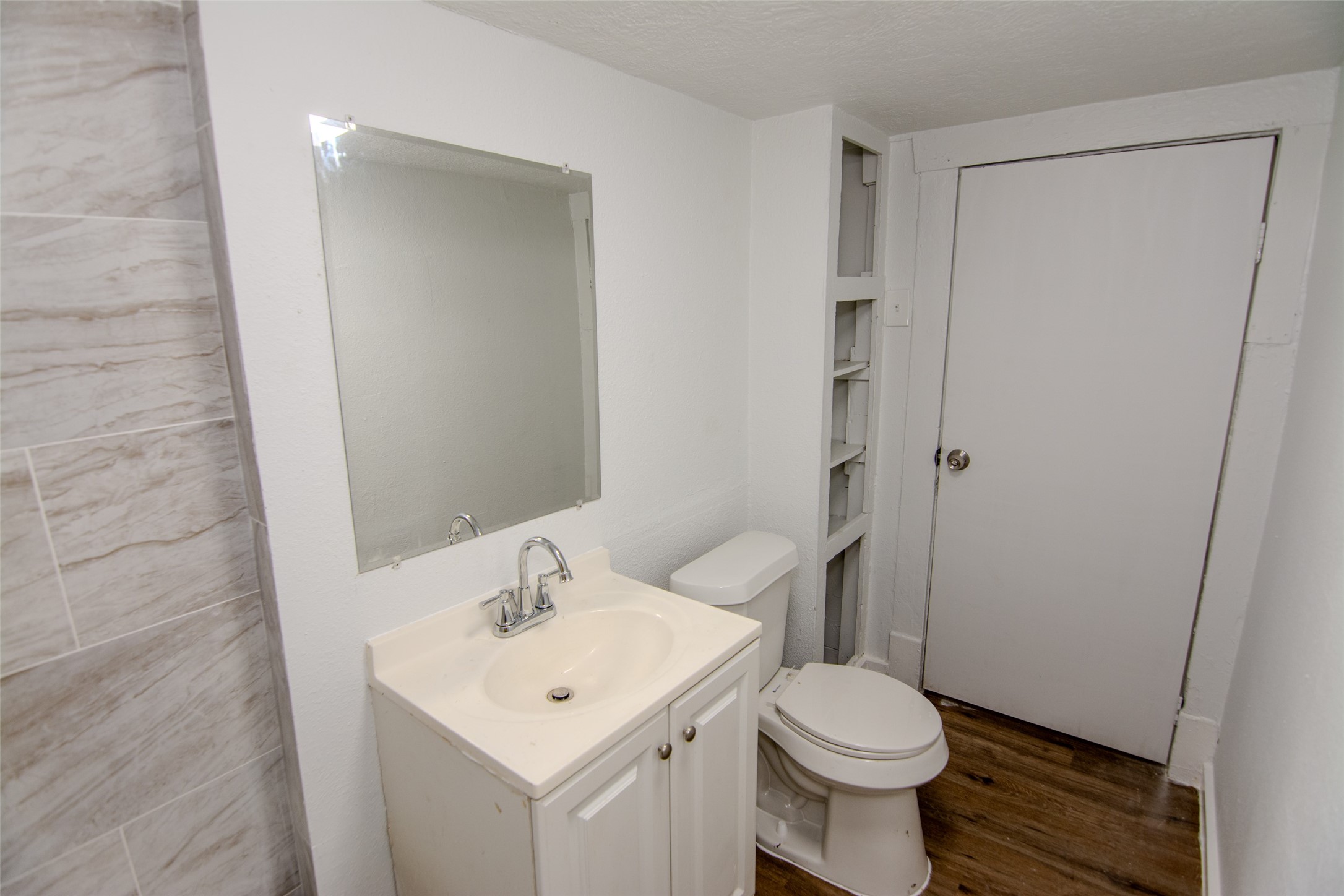 3307 Broadway Street, Unit 2 Houston, TX 77017 - Photo 5 of 8 a bathroom with a sink toilet and a mirror