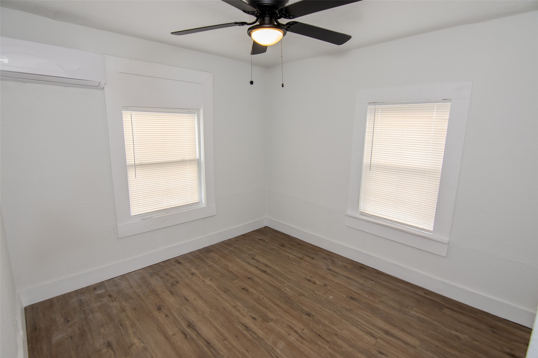 3307 Broadway Street, Unit 2 Houston, TX 77017 - Photo 6 of 8 an empty room with window and a ceiling fan