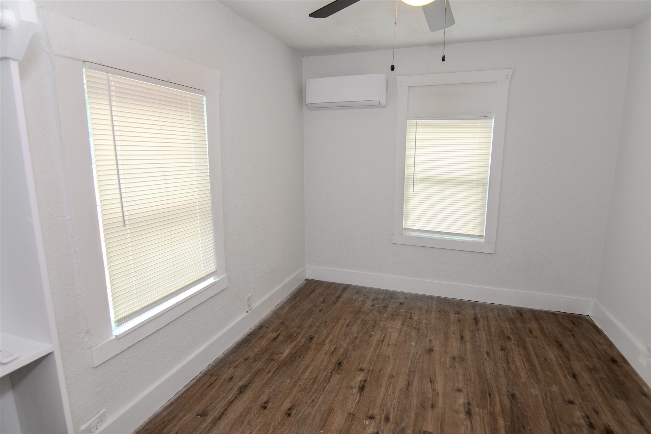 3307 Broadway Street, Unit 2 Houston, TX 77017 - Photo 7 of 8 an empty room with wooden floor and windows