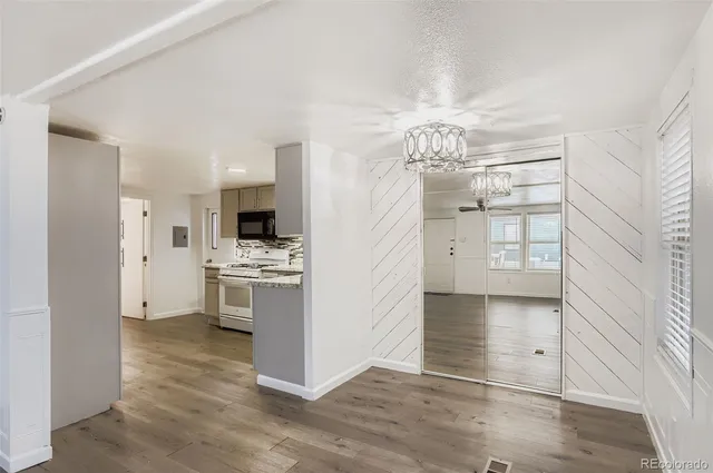 a view of a kitchen with a sink a refrigerator and window