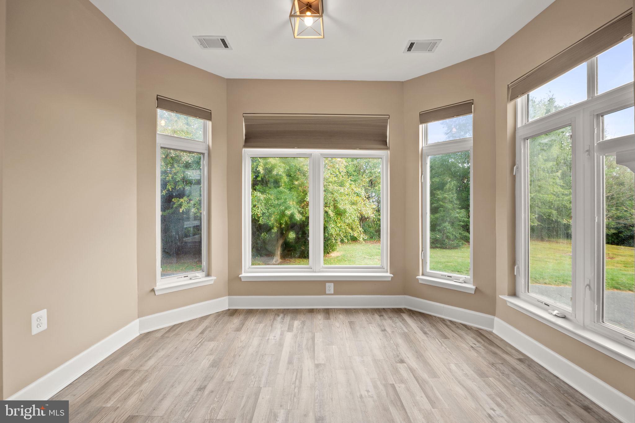 1621 Ladue Court, Unit 105 Woodbridge, VA 22191 - Photo 12 of 60 a view of an empty room with wooden floor and a window