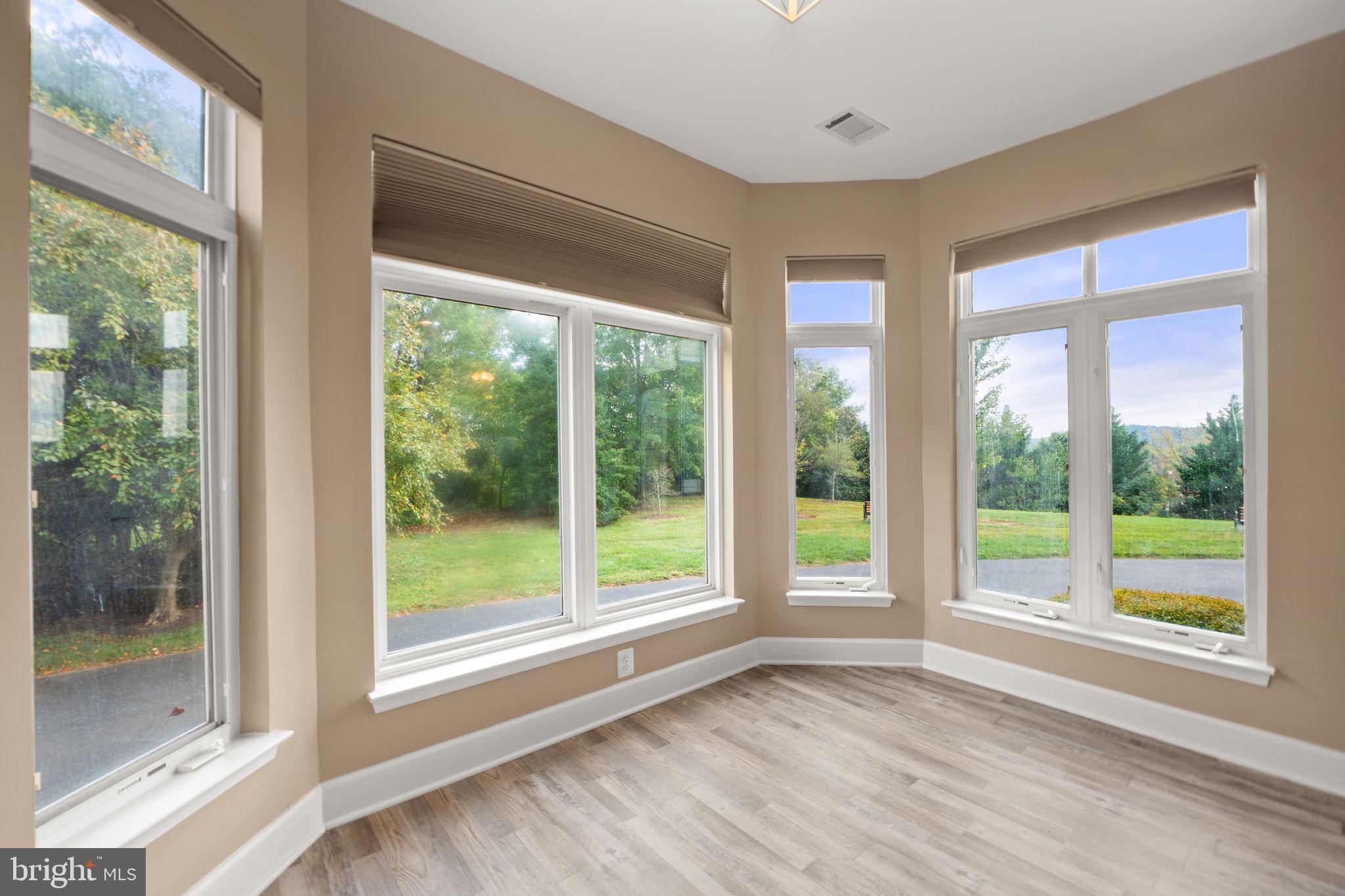 1621 Ladue Court, Unit 105 Woodbridge, VA 22191 - Photo 13 of 60 a view of an empty room with wooden floor and a window