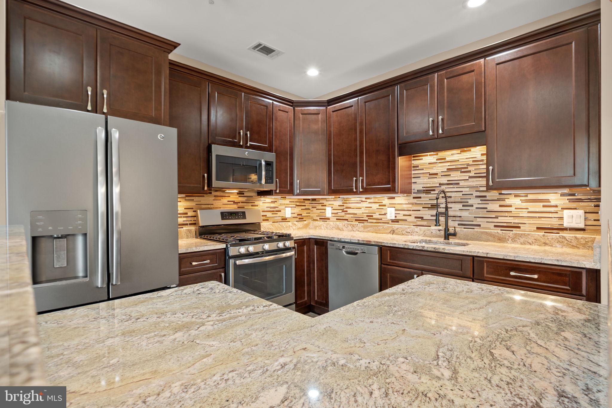 1621 Ladue Court, Unit 105 Woodbridge, VA 22191 - Photo 17 of 60 a kitchen with granite countertop stainless steel appliances and wooden cabinets