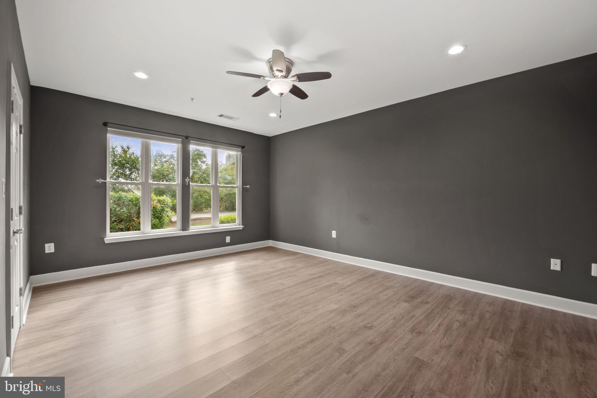 1621 Ladue Court, Unit 105 Woodbridge, VA 22191 - Photo 22 of 60 an empty room with wooden floor and windows