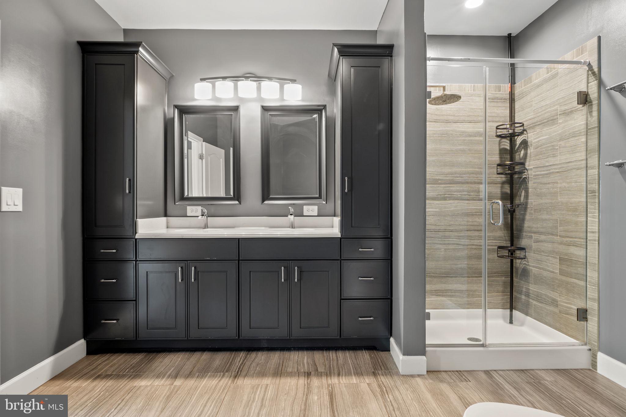 1621 Ladue Court, Unit 105 Woodbridge, VA 22191 - Photo 24 of 60 a bathroom with a shower sink and mirror