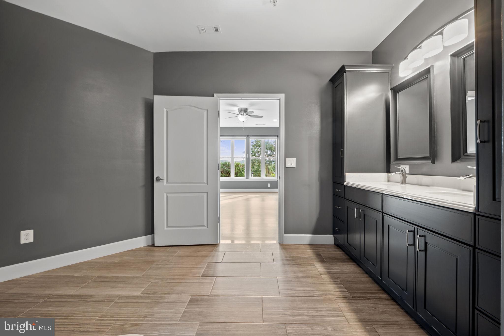 1621 Ladue Court, Unit 105 Woodbridge, VA 22191 - Photo 26 of 60 a bathroom with a sink and mirror
