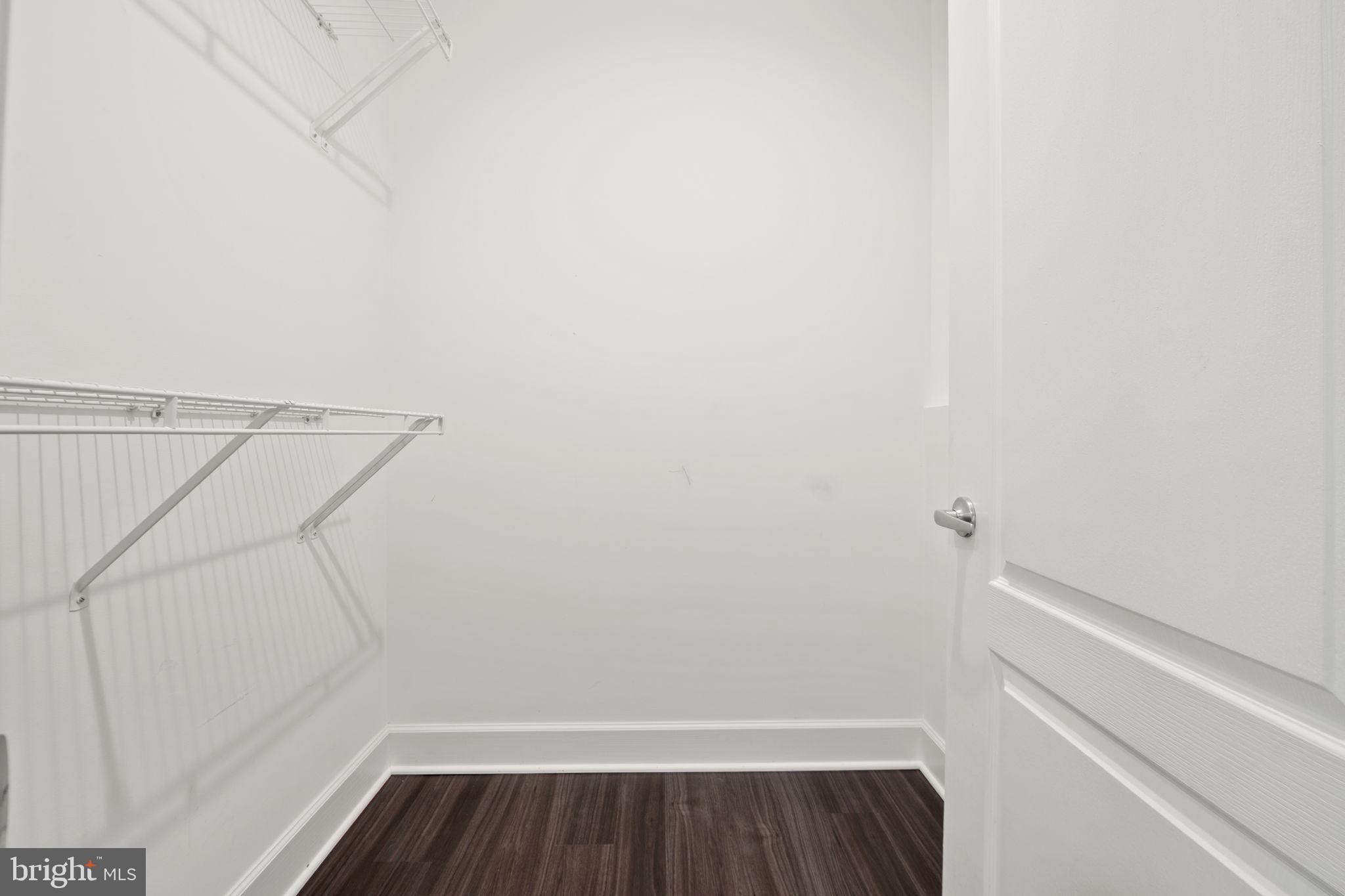 1621 Ladue Court, Unit 105 Woodbridge, VA 22191 - Photo 31 of 60 a view of walk in closet with wooden floor