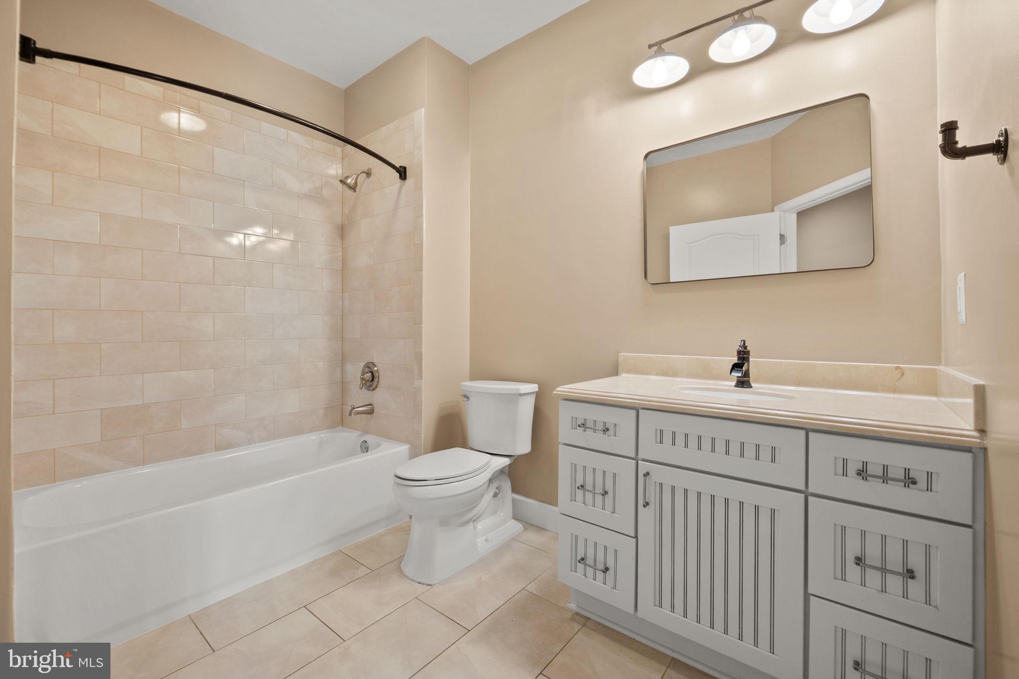 1621 Ladue Court, Unit 105 Woodbridge, VA 22191 - Photo 32 of 60 a spacious bathroom with a double vanity sink a toilet and shower