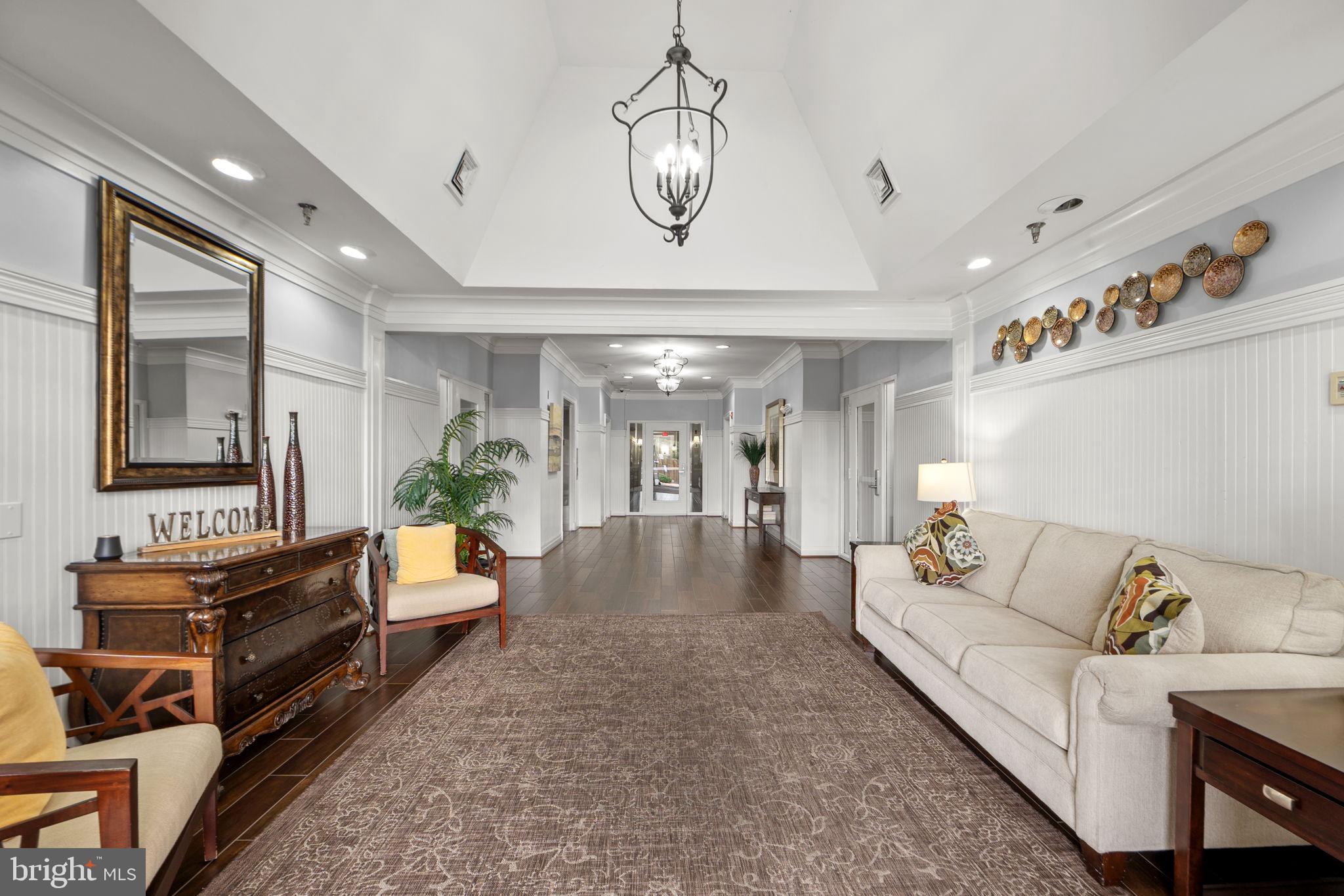 1621 Ladue Court, Unit 105 Woodbridge, VA 22191 - Photo 42 of 60 a living room with furniture and a chandelier