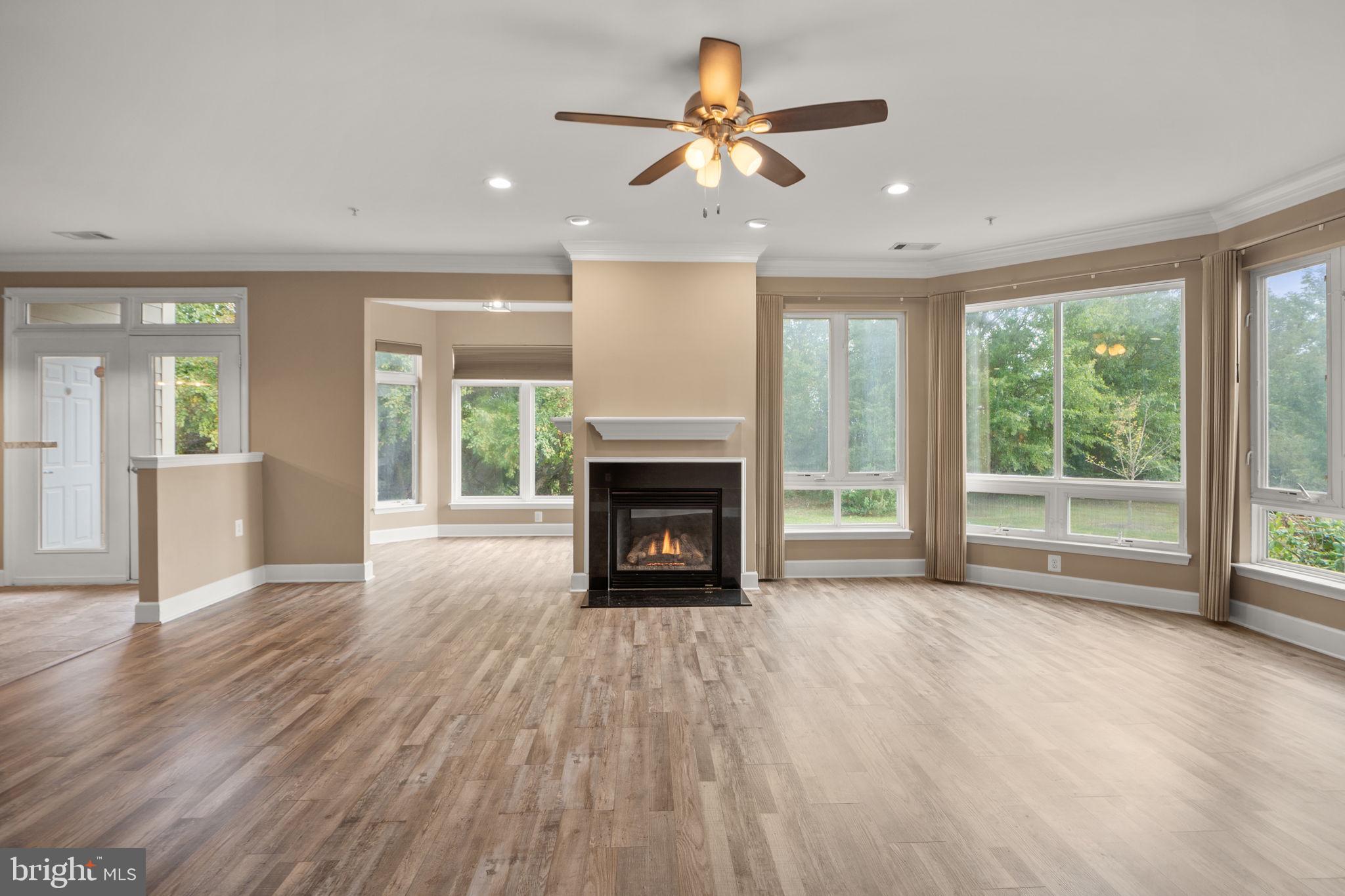 1621 Ladue Court, Unit 105 Woodbridge, VA 22191 - Photo 6 of 60 a view of an empty room with wooden floor fireplace and a window