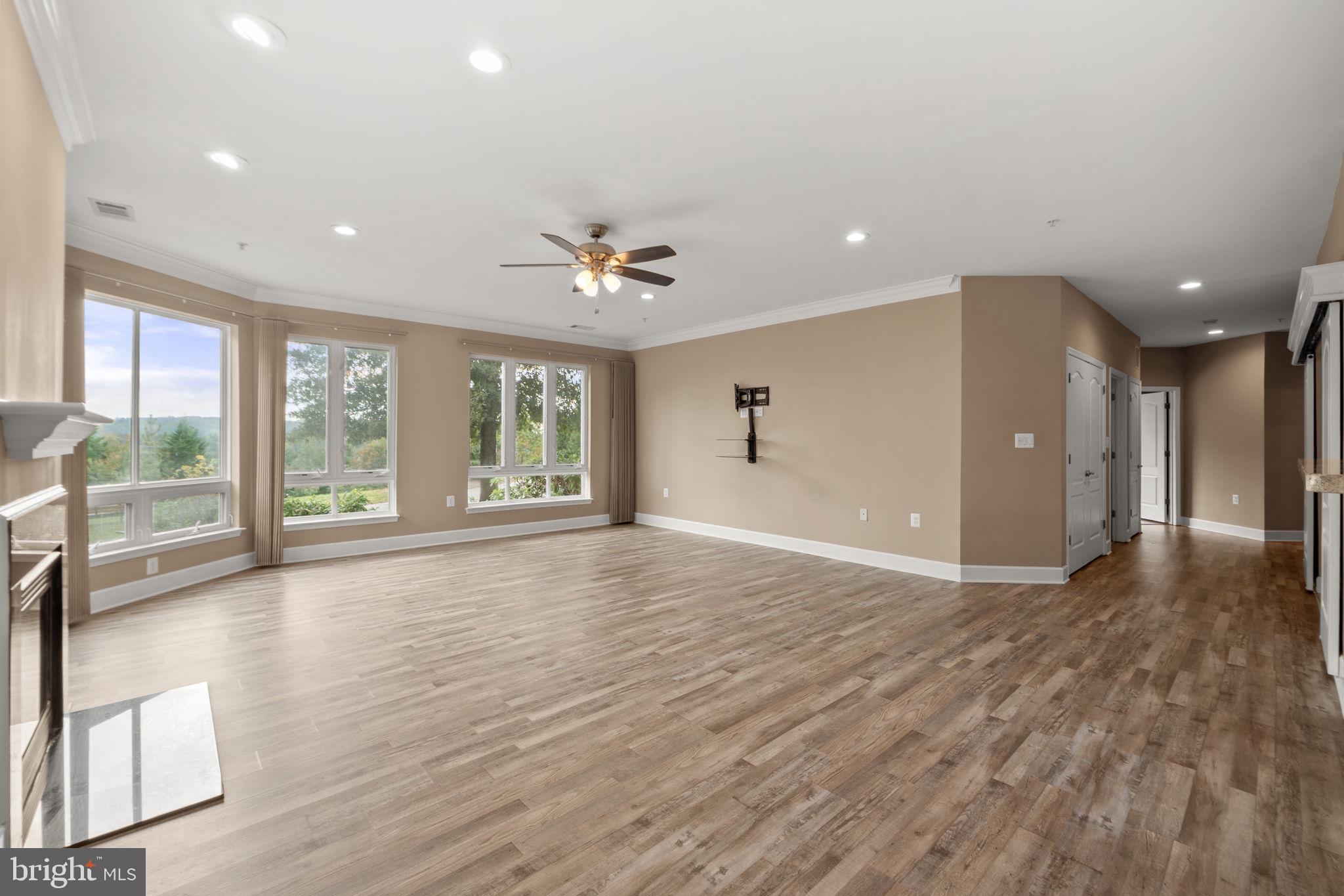 1621 Ladue Court, Unit 105 Woodbridge, VA 22191 - Photo 9 of 60 a view of an empty room with a window and wooden floor
