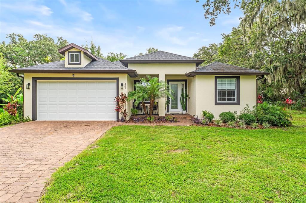 489 Grape Avenue St. Cloud, FL 34769 - Photo 1 of 1 a front view of a house with a yard and garage