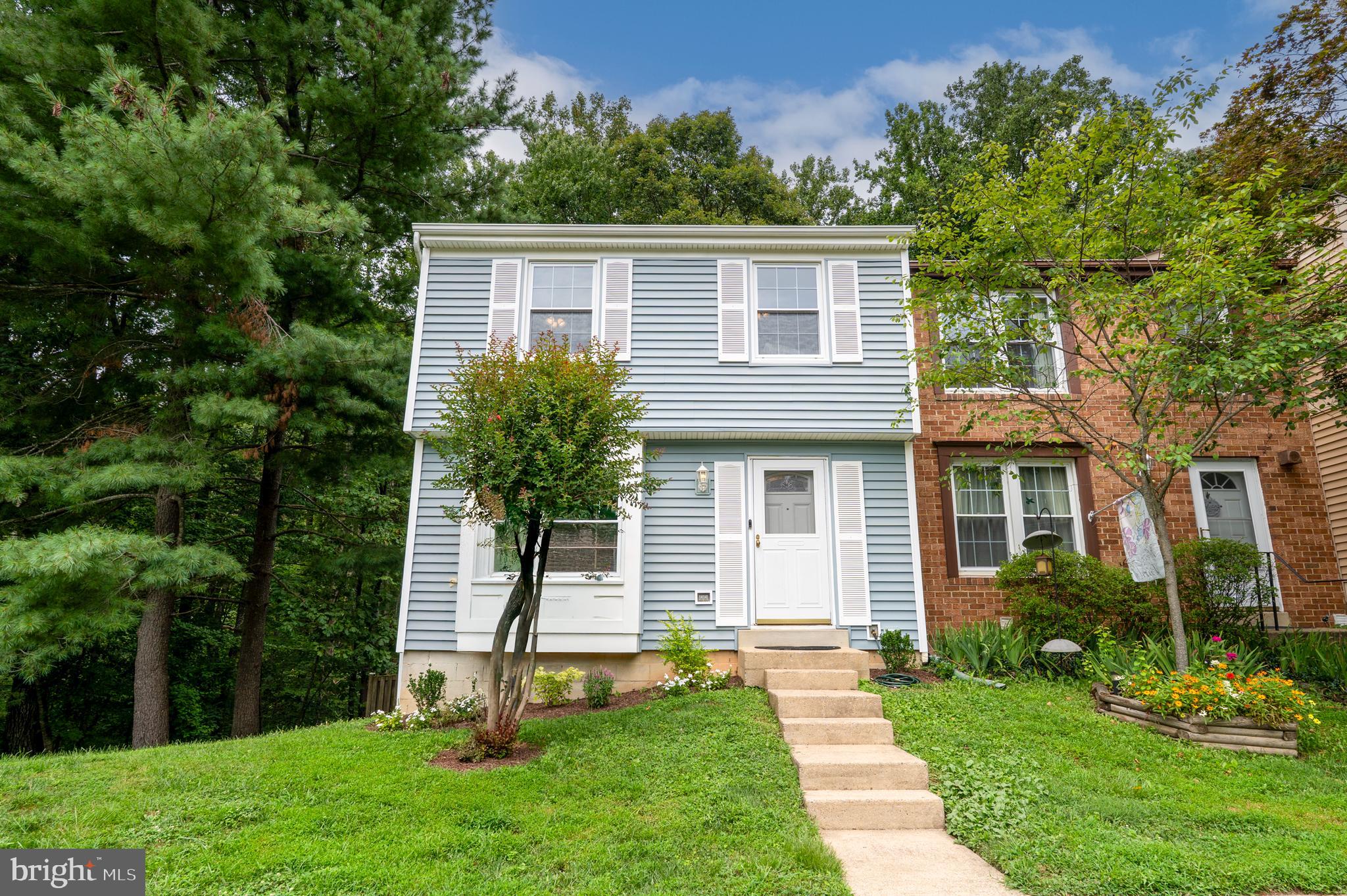 a house that has a tree in front of a house