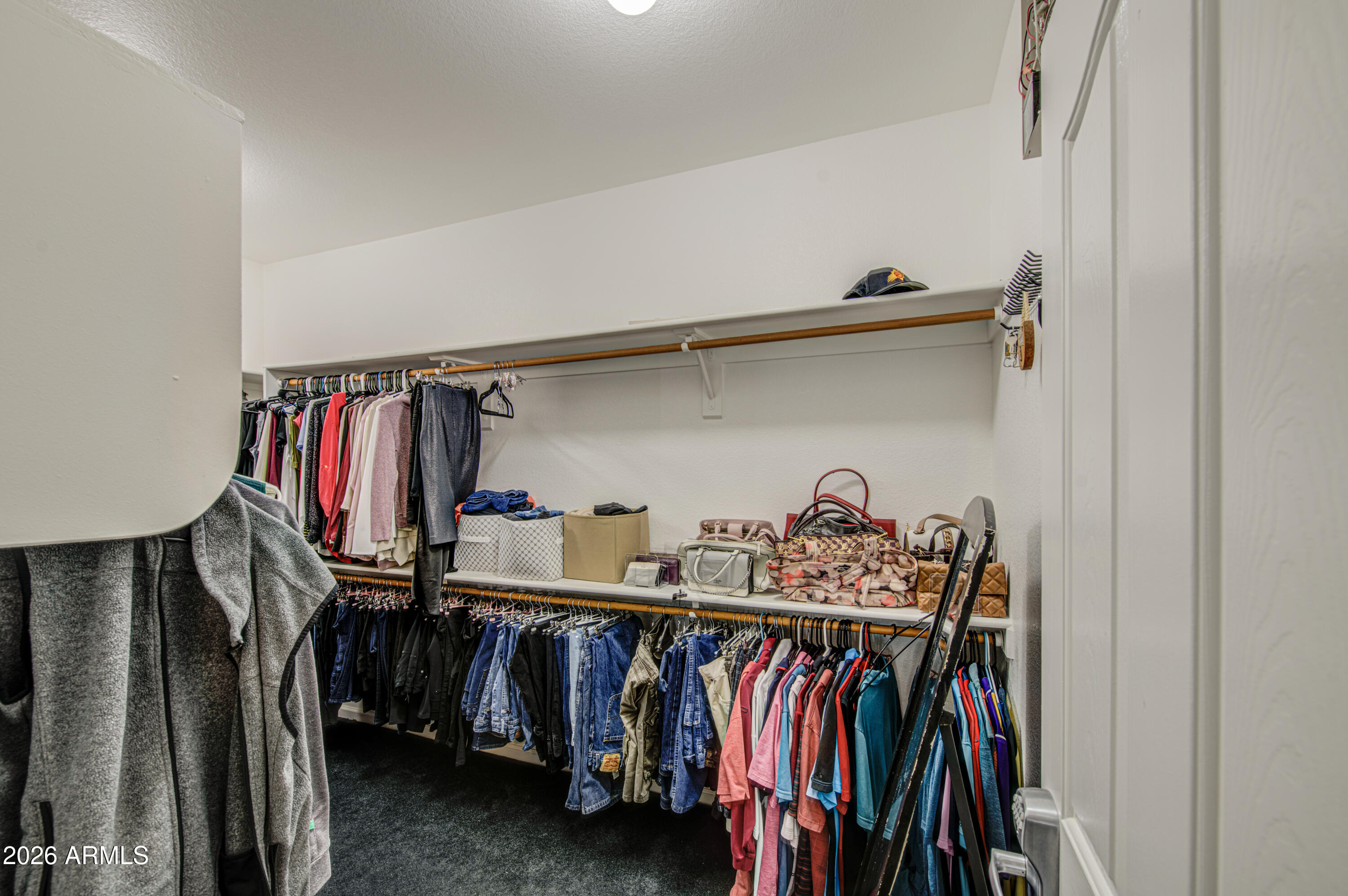 12403 West Monte Vista Road Avondale, AZ 85392 - Photo 32 of 63 a view of walk in closet with clothes