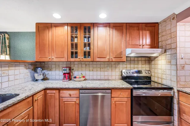 a living room with furniture and floor to ceiling windows