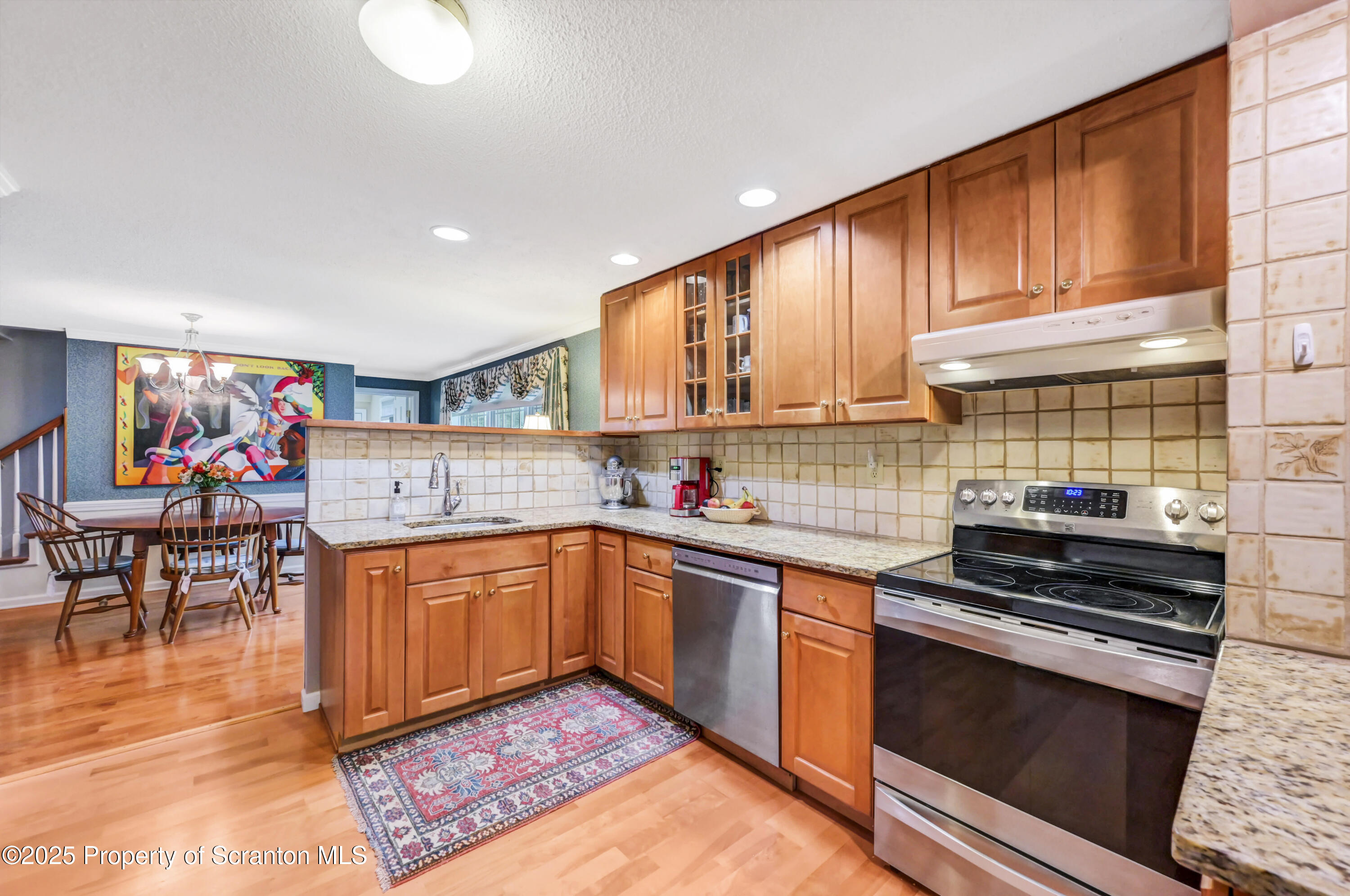 353 Benton Road Dalton, PA 18414 - Photo 14 of 78 a kitchen with stainless steel appliances granite countertop a stove a sink and a microwave