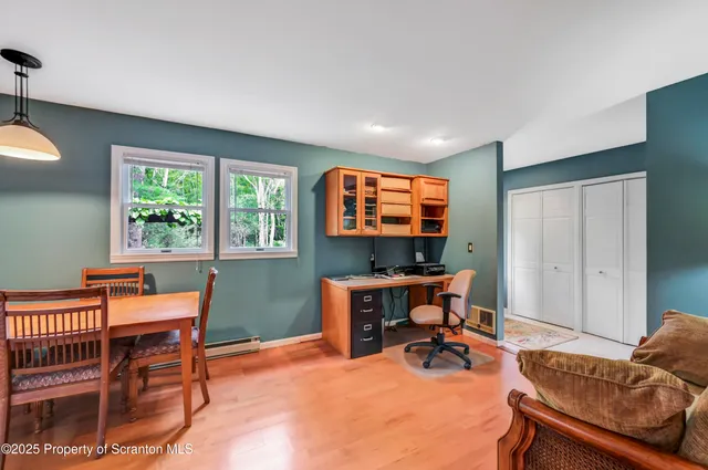 a living room with furniture a flat screen tv and a large window