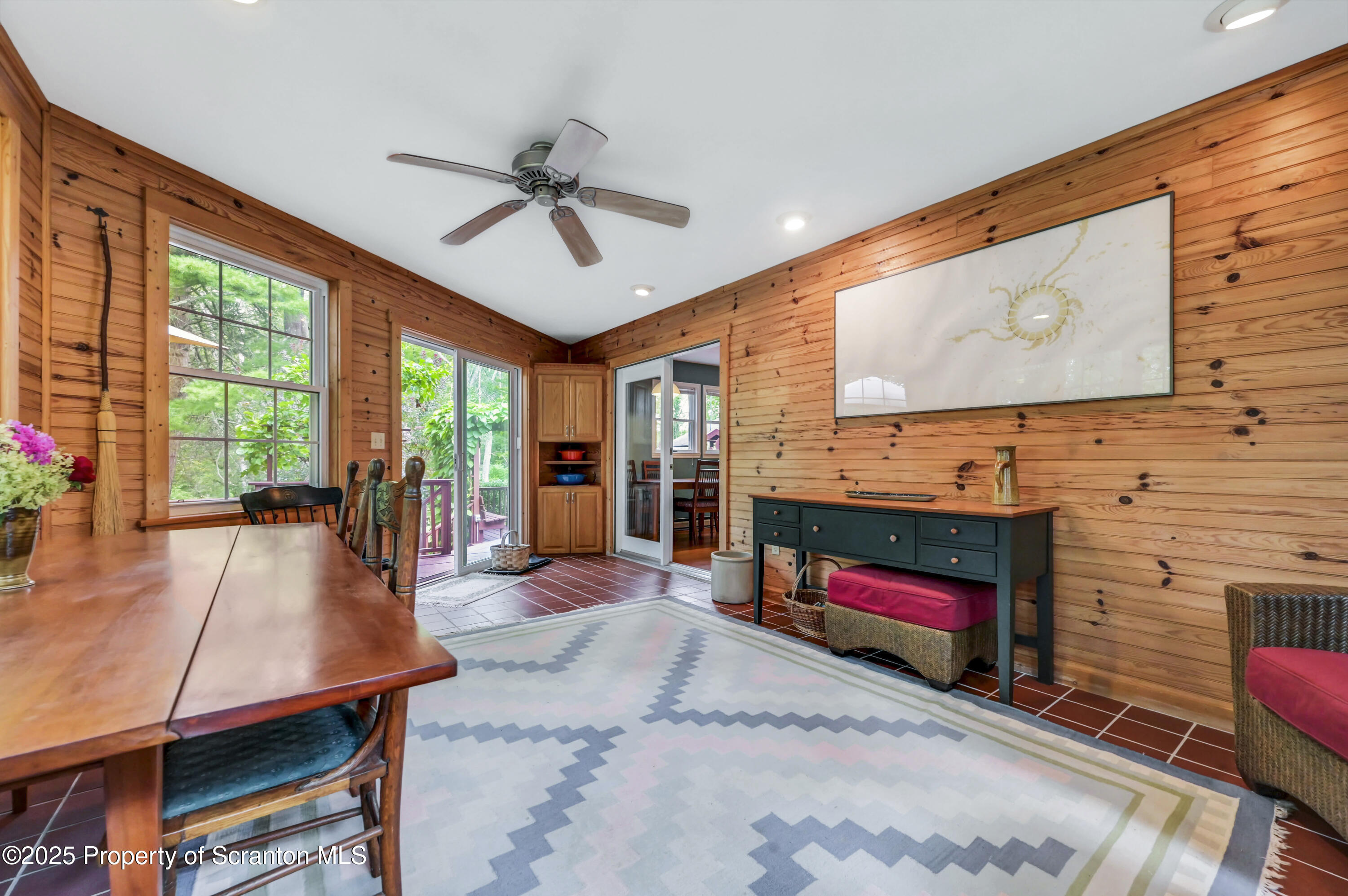 353 Benton Road Dalton, PA 18414 - Photo 25 of 78 a living room with furniture a flat screen tv and a large window