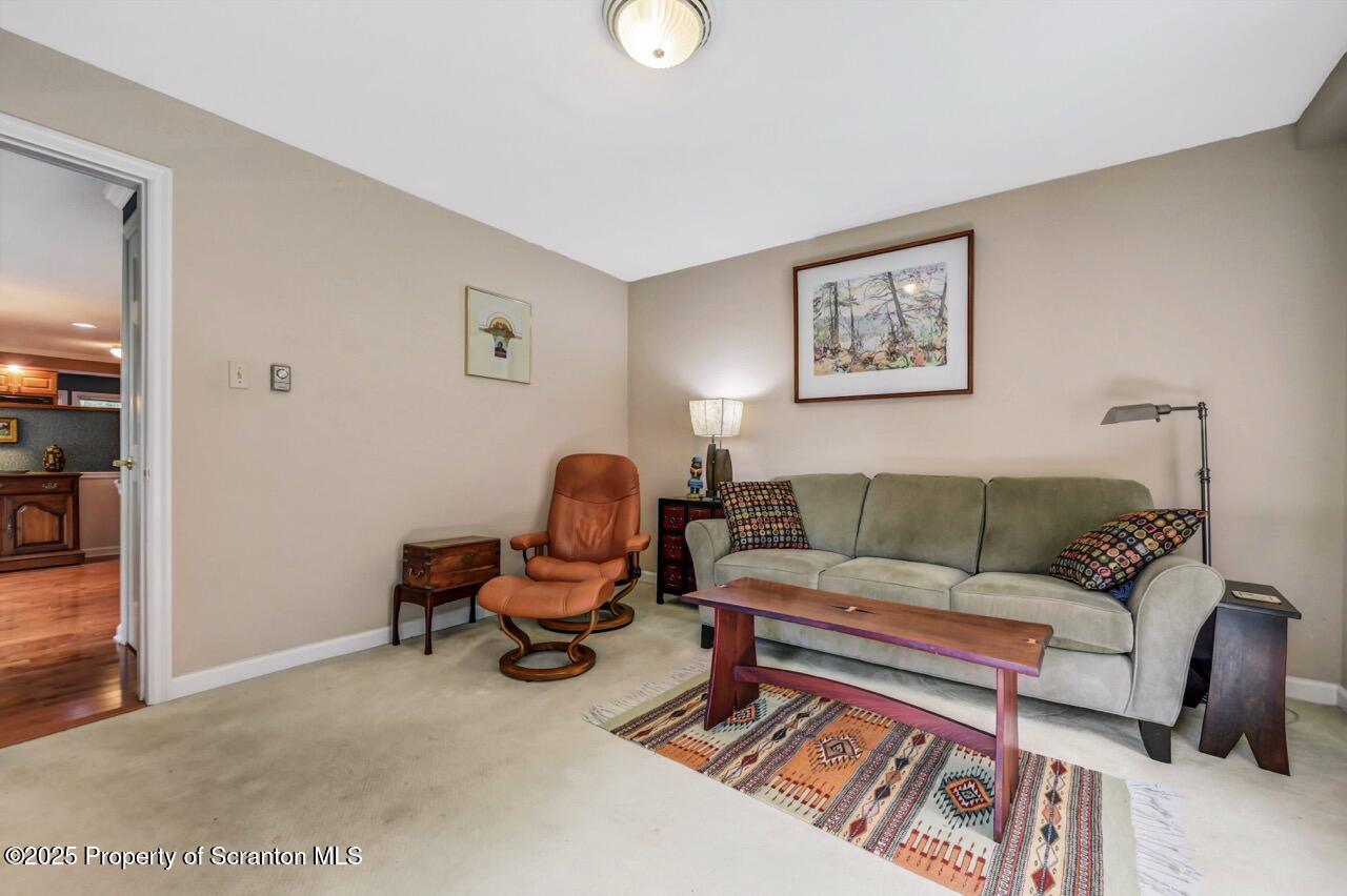 353 Benton Road Dalton, PA 18414 - Photo 27 of 78 a living room with furniture and a lamp