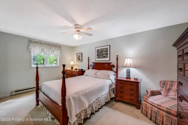 a view of a livingroom with wooden floor and stairs