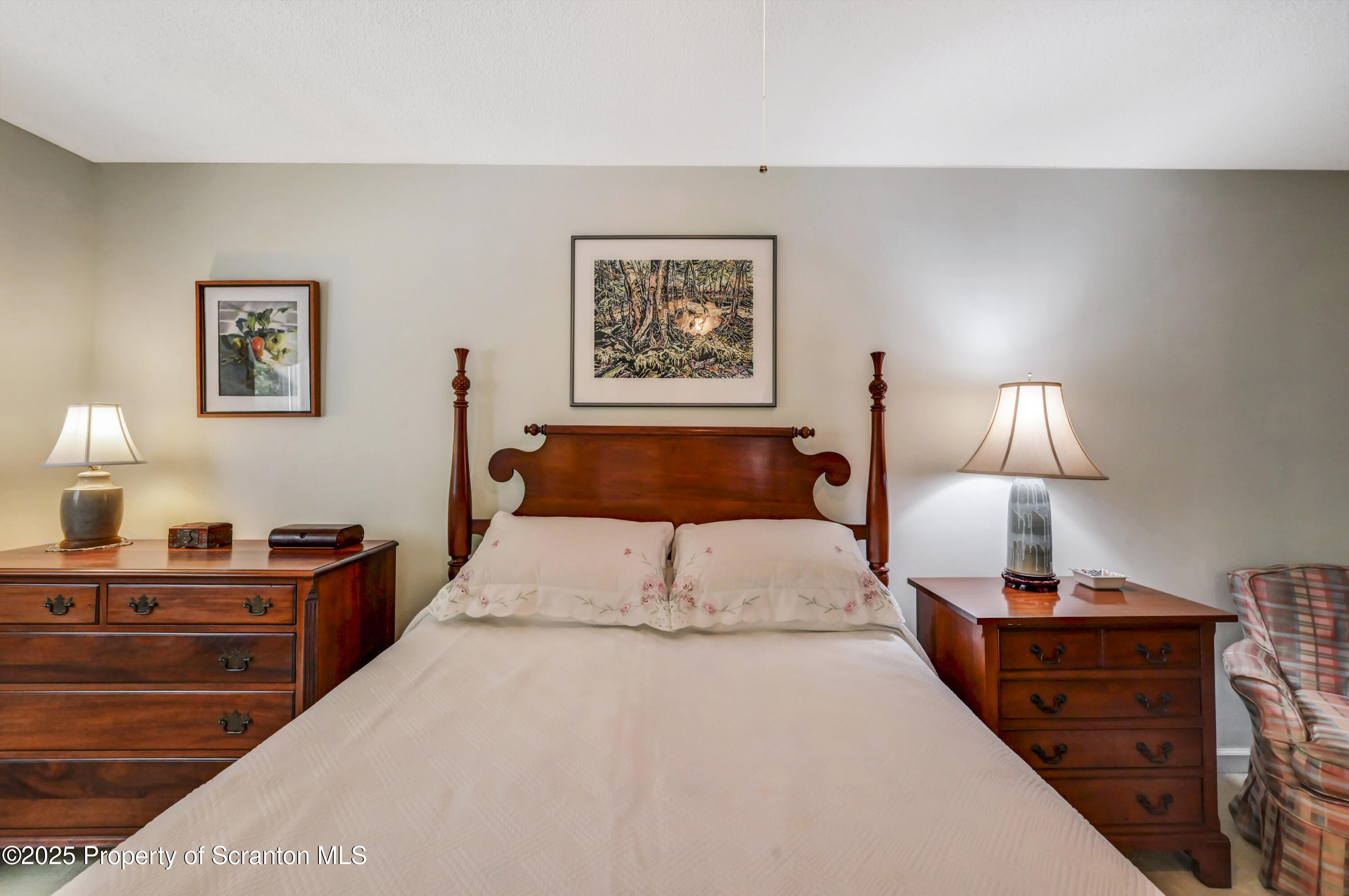 353 Benton Road Dalton, PA 18414 - Photo 30 of 78 a bedroom with a bed and a lamp on dresser