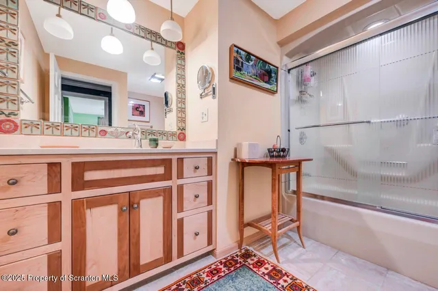 a view of a patio with furniture and umbrella