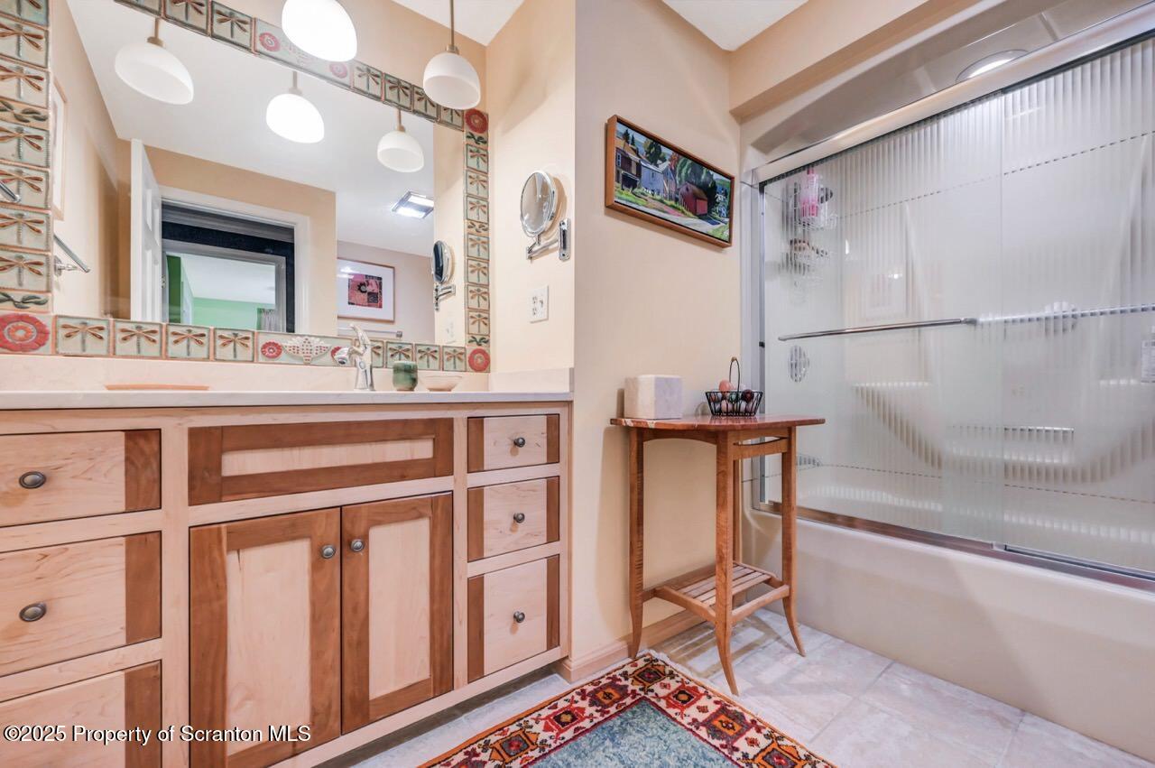 353 Benton Road Dalton, PA 18414 - Photo 33 of 78 a bathroom with a sink a mirror and a bathtub