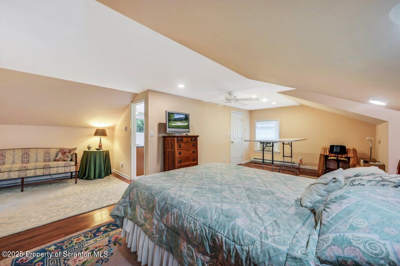 353 Benton Road Dalton, PA 18414 - Photo 41 of 78 a spacious bedroom with a bed a mirror and window